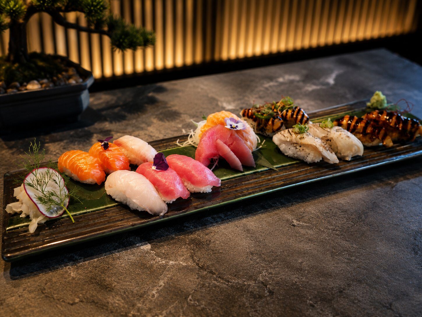 Assorted sashimi and nigiri on a white plate