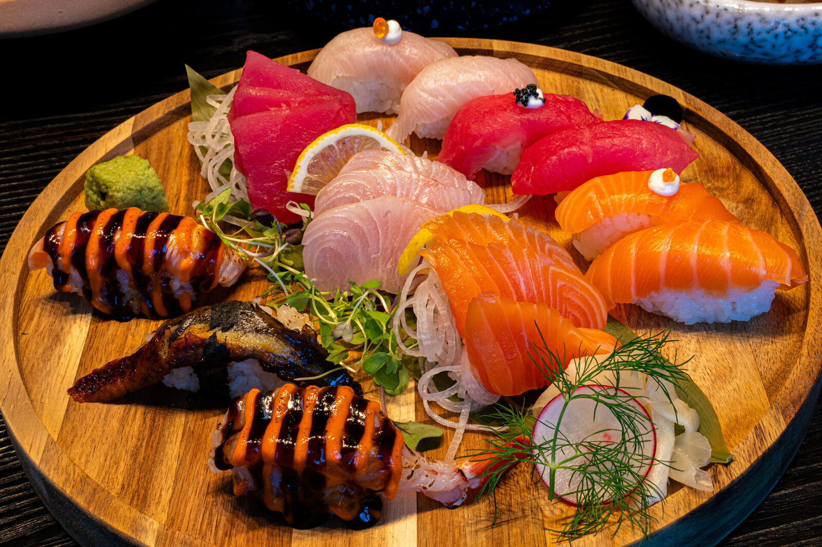 Chef's selection of nigiri and sashimi on a wooden board